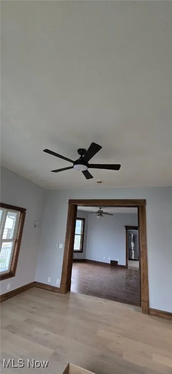 Unfurnished room with wood finished floors and ceiling fan