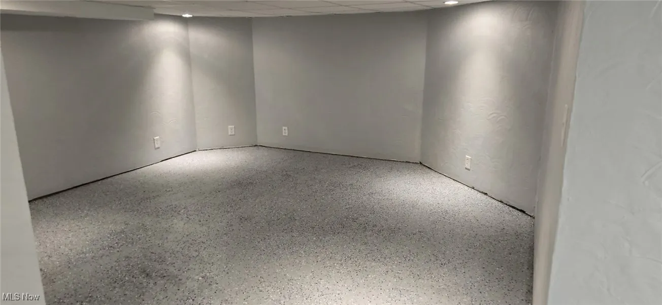 Empty room featuring speckle patterned floor