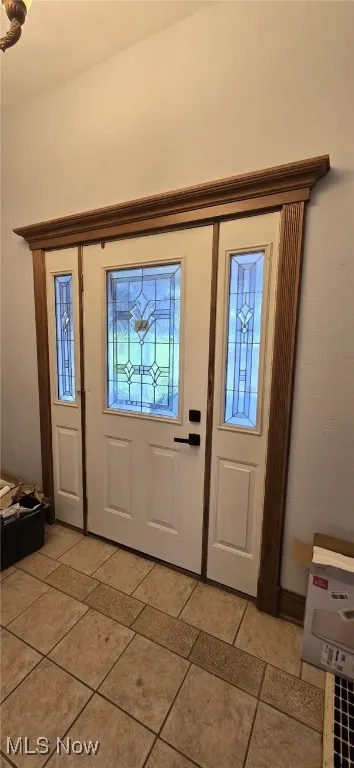 Entryway featuring light tile patterned floors