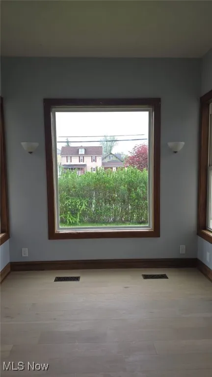 Empty room with wood finished floors and baseboards