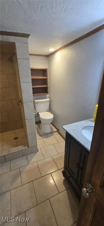 Full bathroom featuring vanity, a shower stall, and tile patterned floors