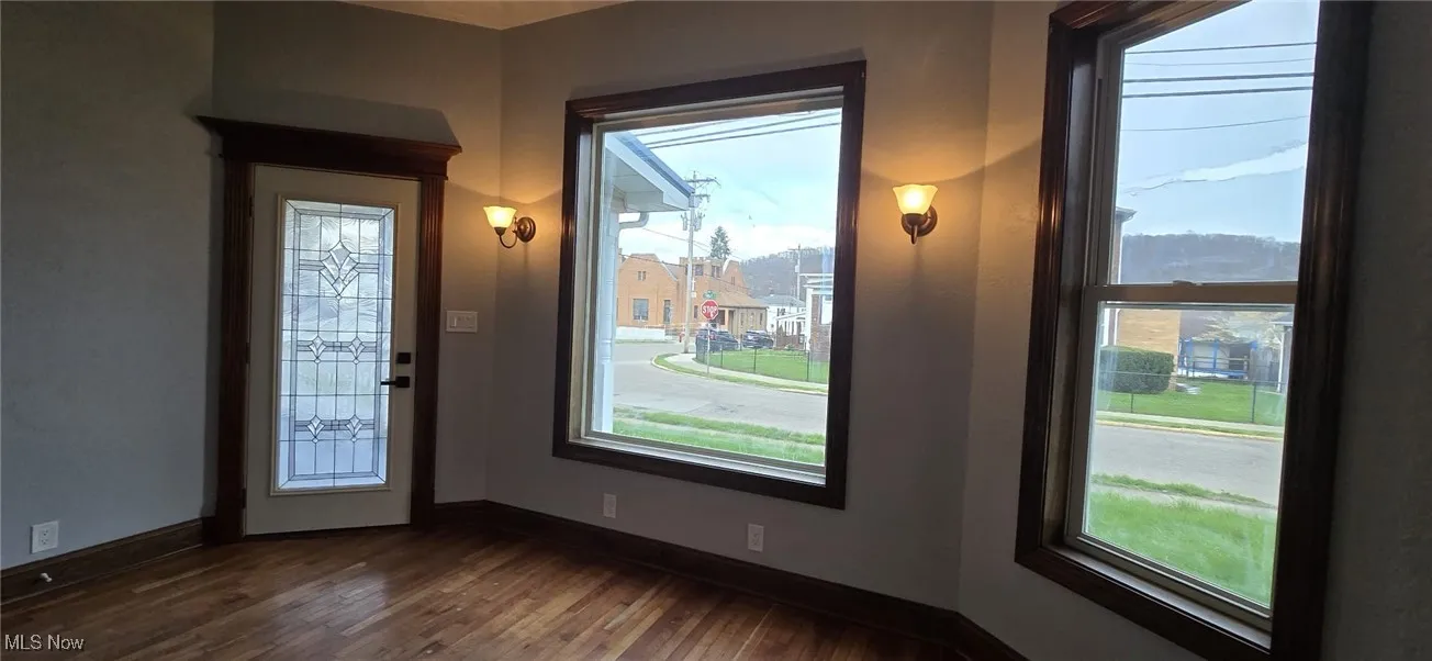 Entryway featuring dark wood finished floors and baseboards