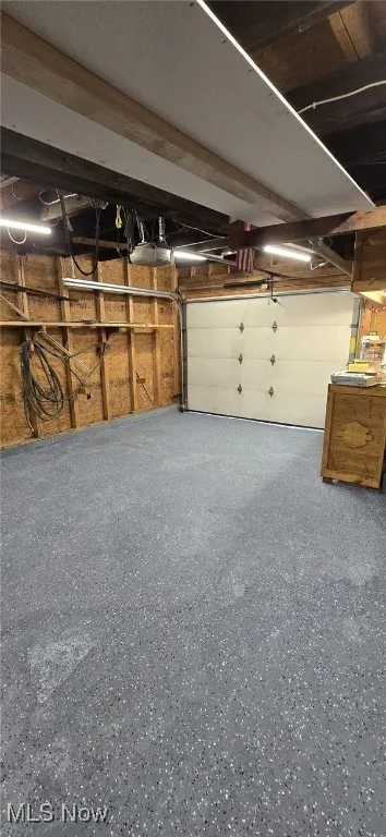 Garage featuring a garage door opener