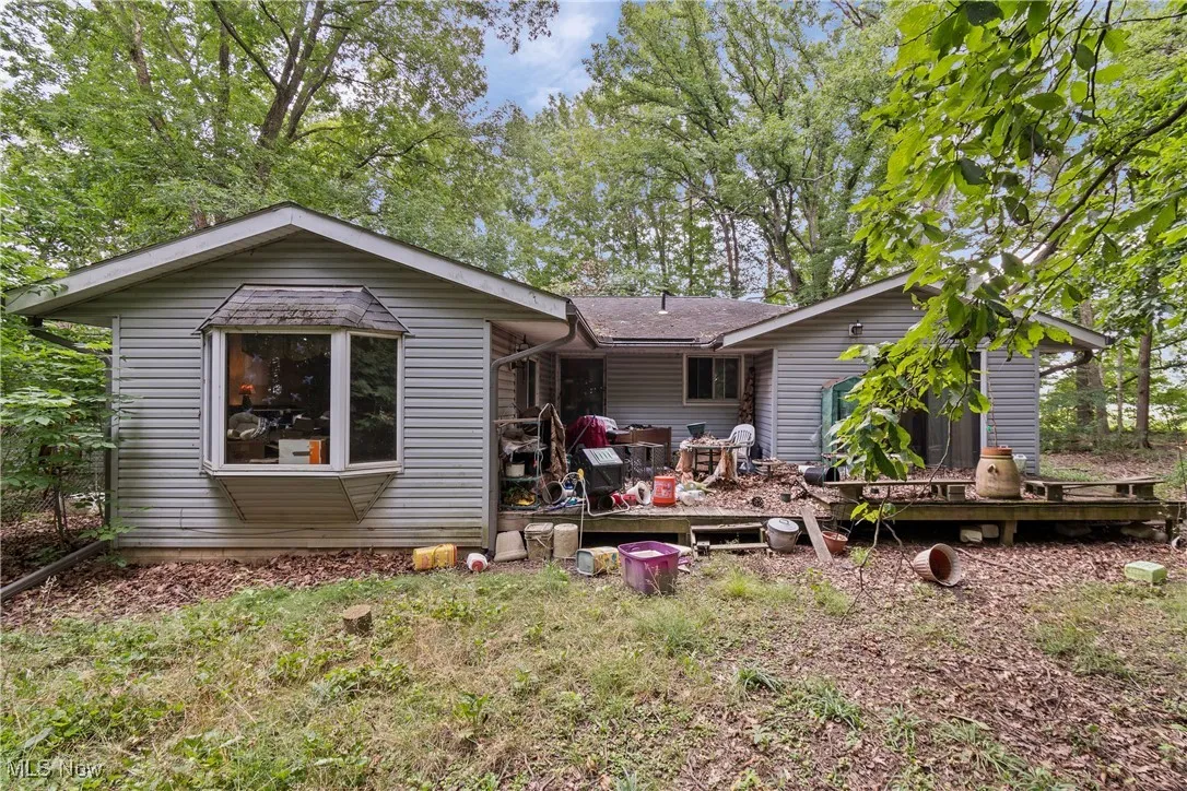 Back of house with a shingled roof