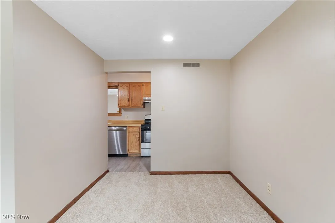 Unfurnished living room featuring light carpet and recessed lighting