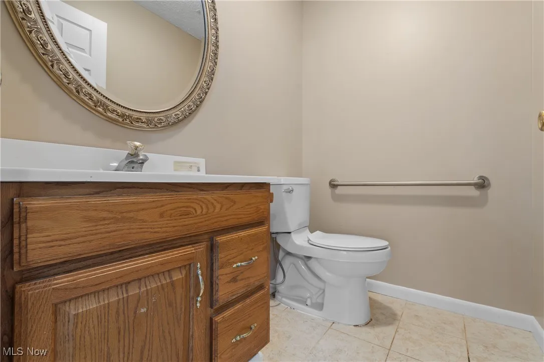 Bathroom featuring tile patterned floors and vanity