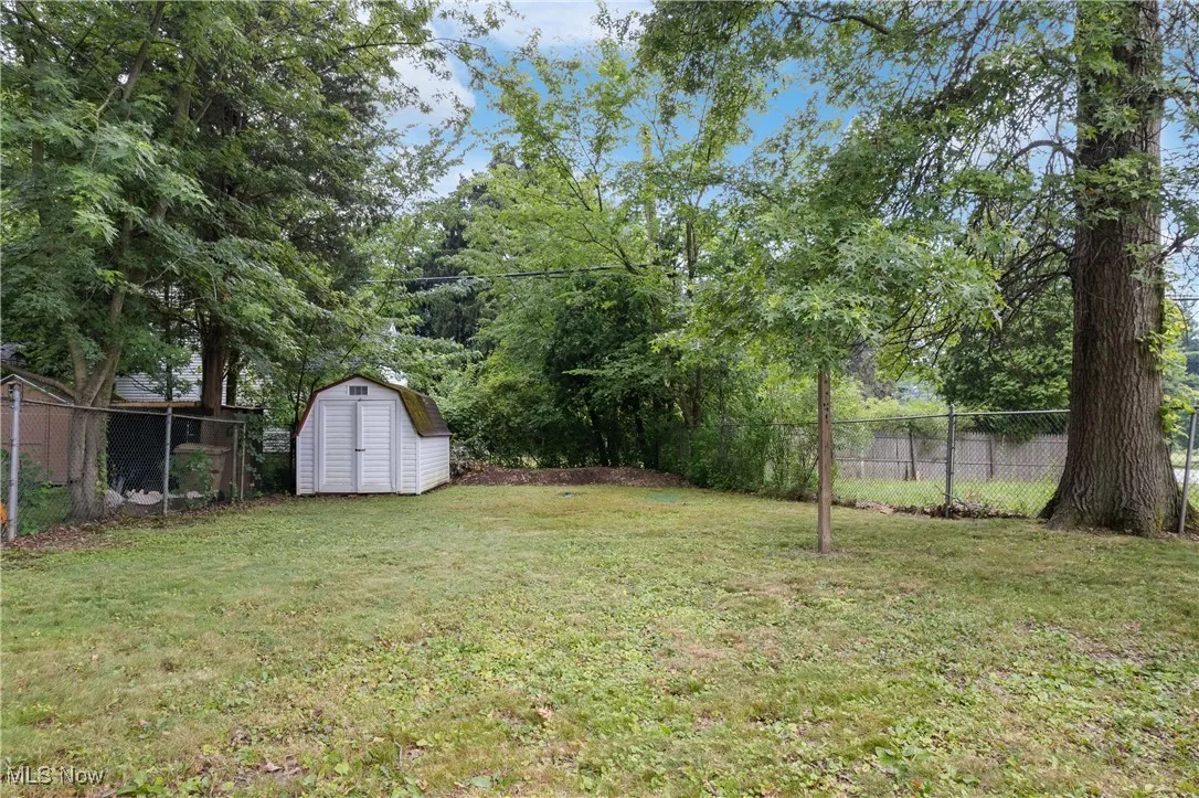 View of yard featuring a storage unit