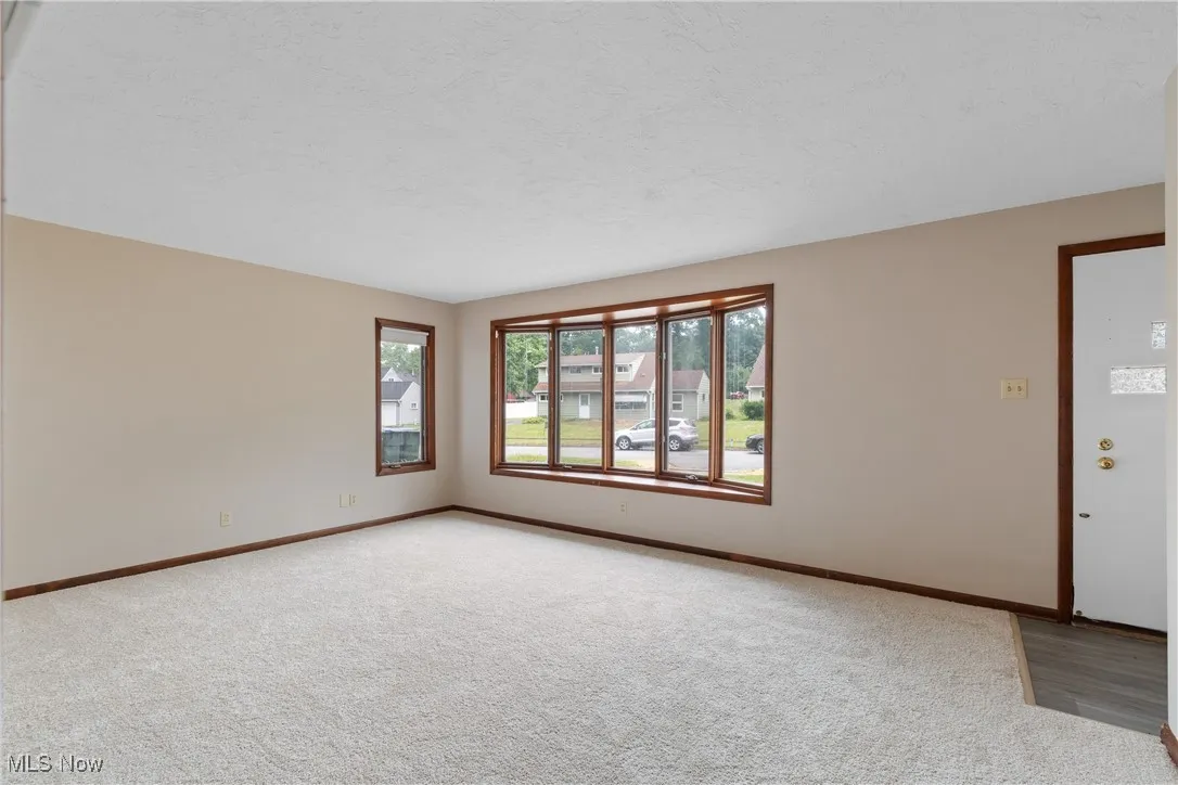 Spare room featuring light carpet and a textured ceiling