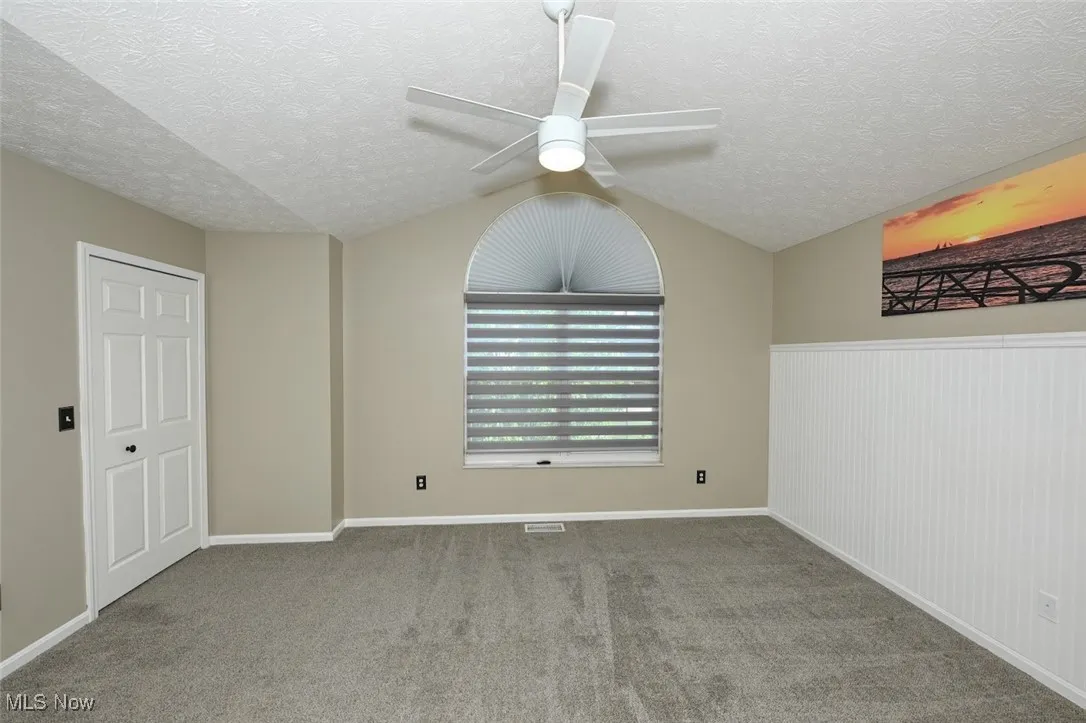 The Owners bedroom has 2 closets (1 is a walk in), a ceiling fan and custom window treatment