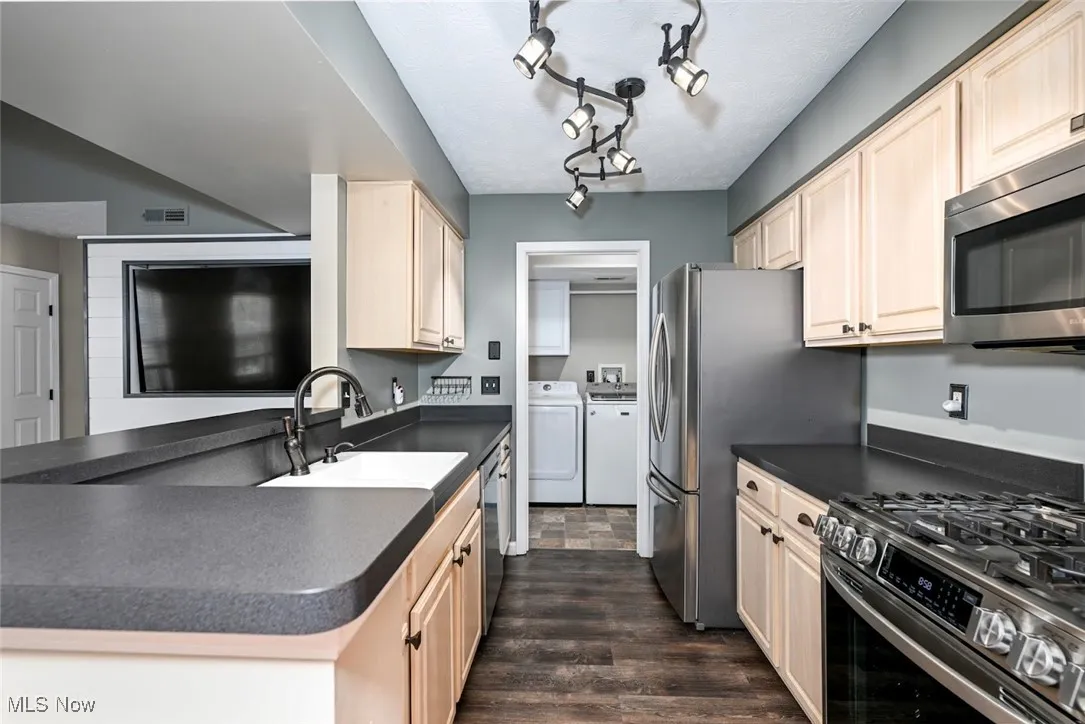 Nicely updated with track lighting, SS appliances and formica counters