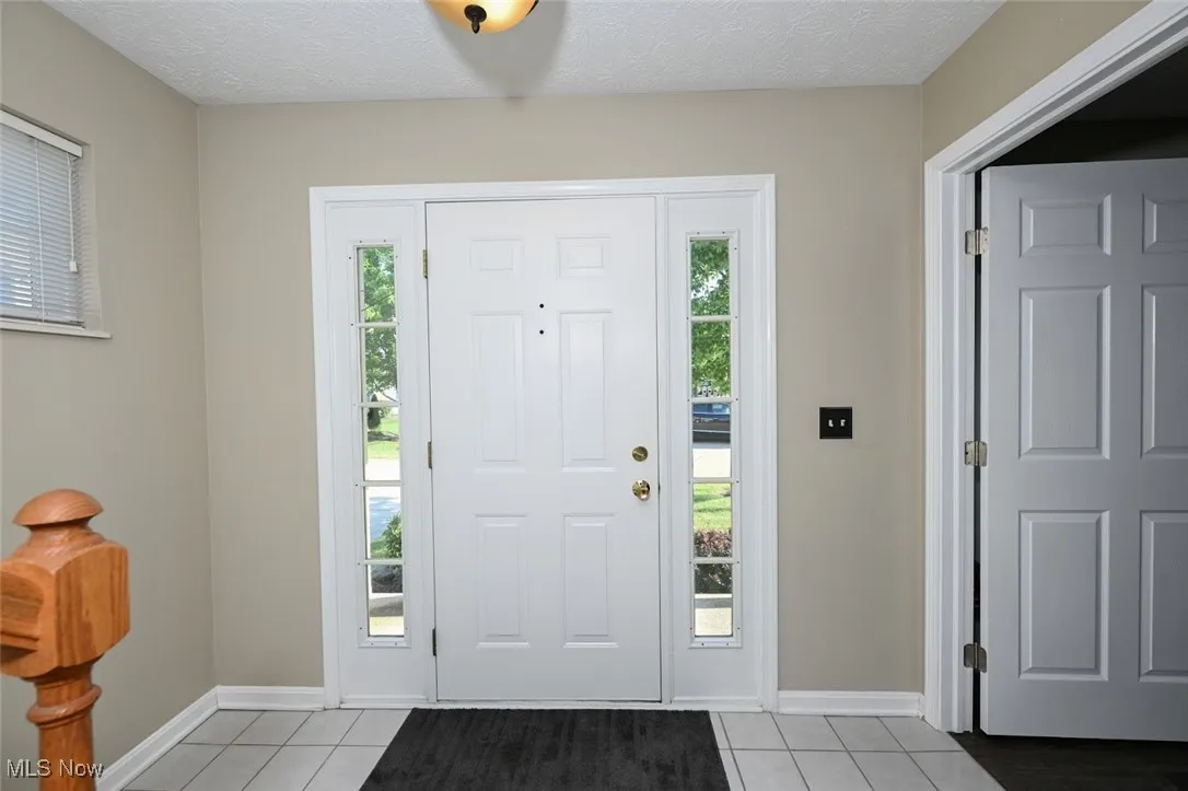 The foyer features ceramic tile/ All of the lighting in the home has been updated.
