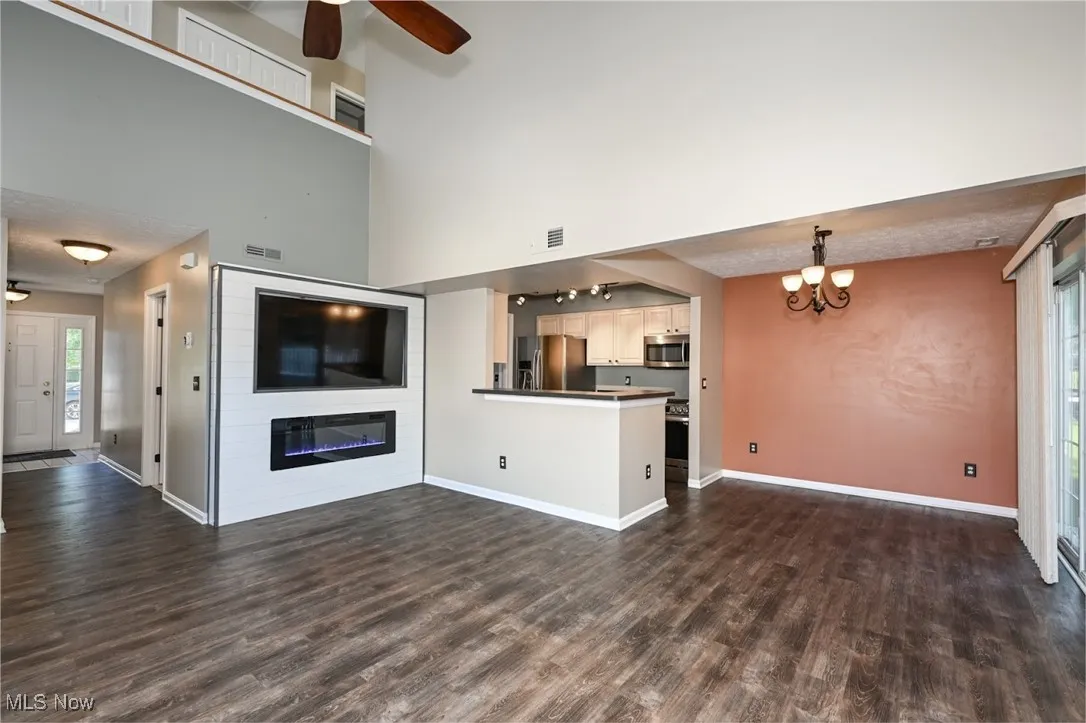The great room has been updated with LVT, a nice ceiling fan and a fireplace surrounded by shiplap
