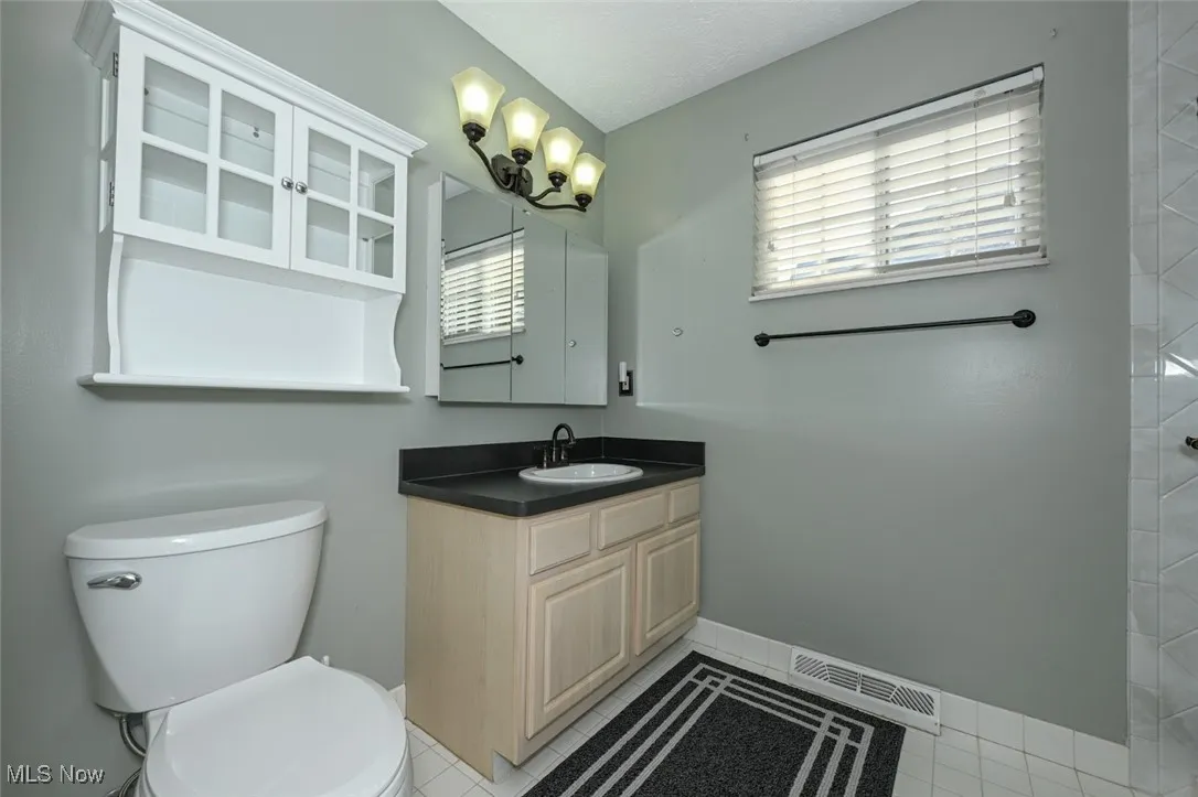 The main bath has been updated as well with ceramic tile and walk in shower