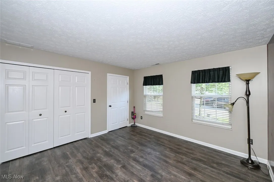 View 2 of the first floor bedroom with a large closet and closet organizer