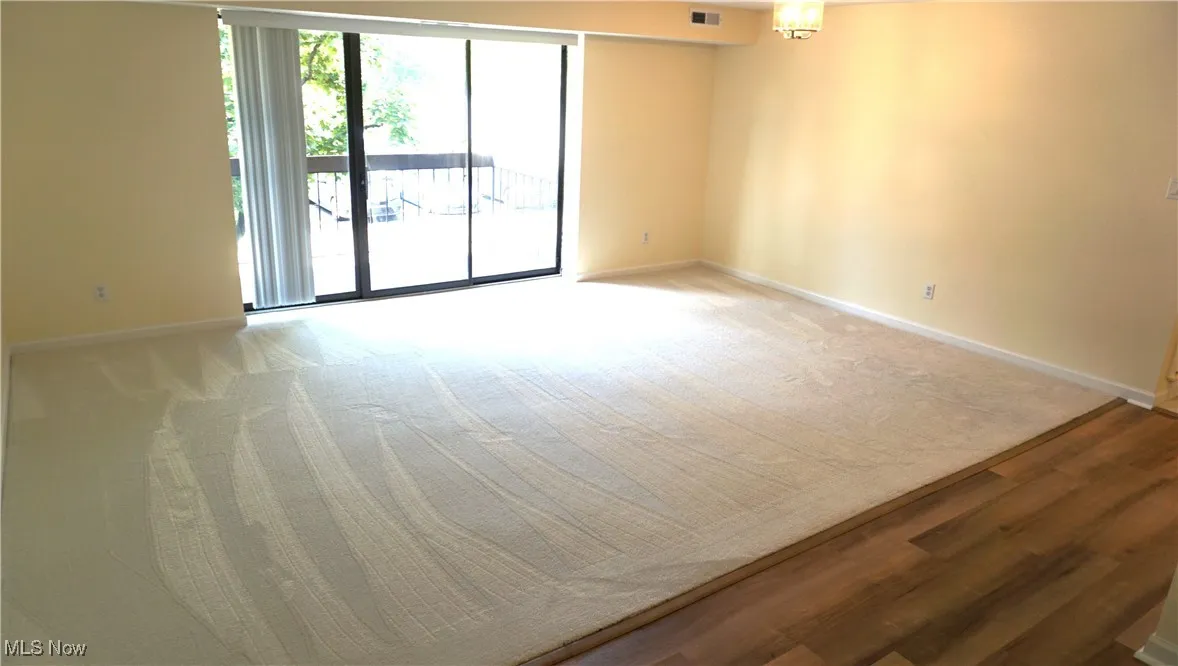 Spare room with baseboards and carpet