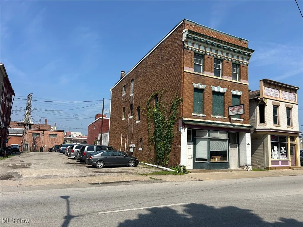 View of property with uncovered parking