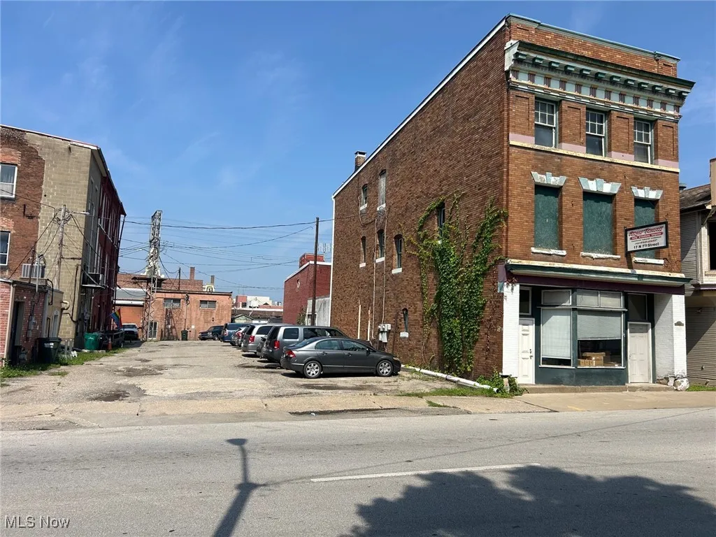 View of property with uncovered parking