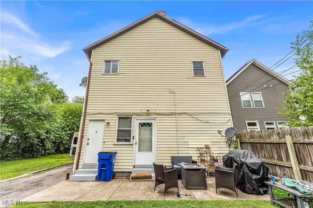 Rear view of property featuring entry steps and a patio