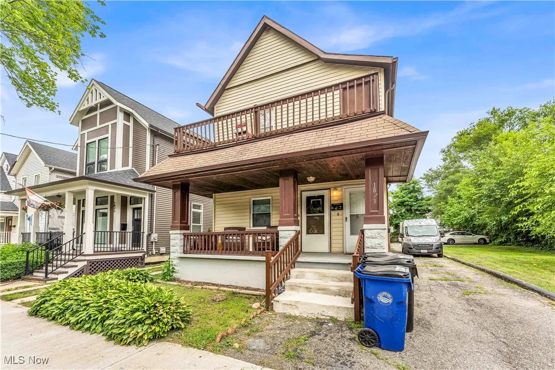 View of front of home featuring a porch, roof with shingles, and a balcony
