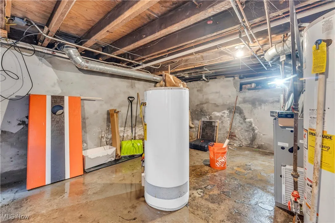 Unfinished below grade area featuring gas water heater