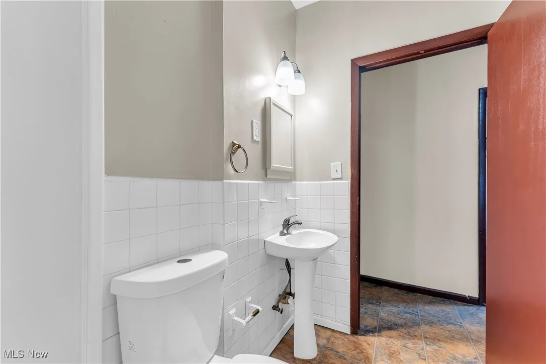 Bathroom featuring tile walls and wainscoting