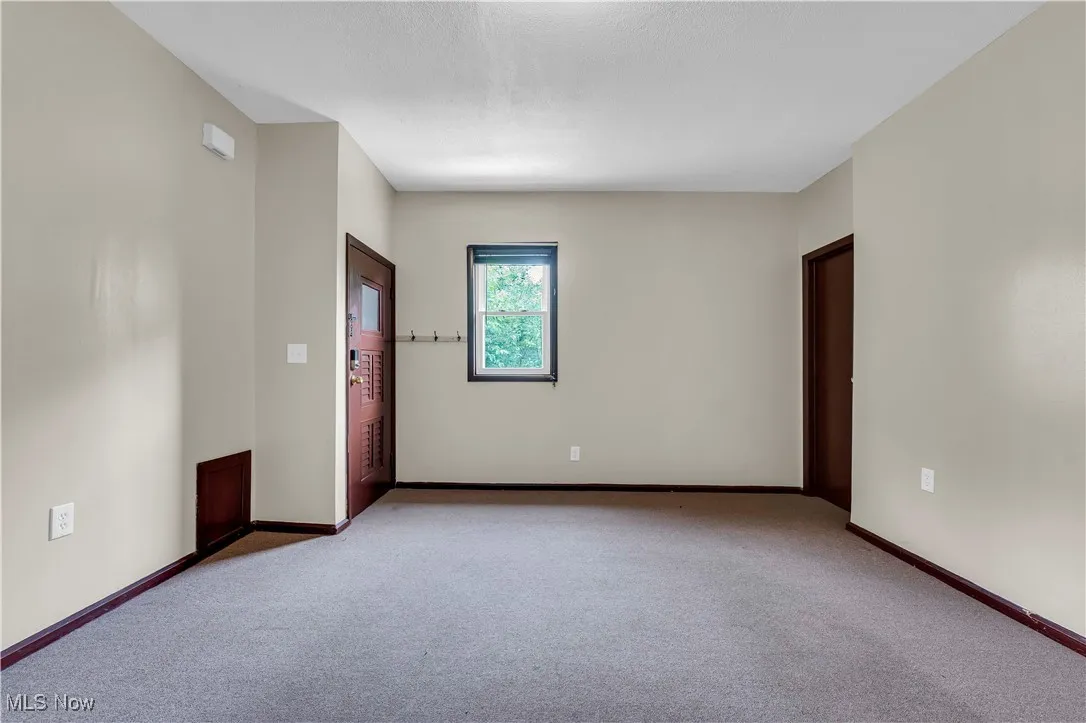 Unfurnished room with carpet flooring