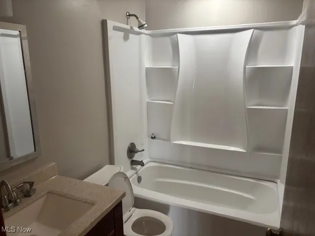 Bathroom with vanity and shower / washtub combination