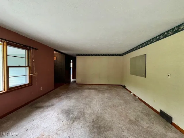 Living room with baseboards and carpet flooring