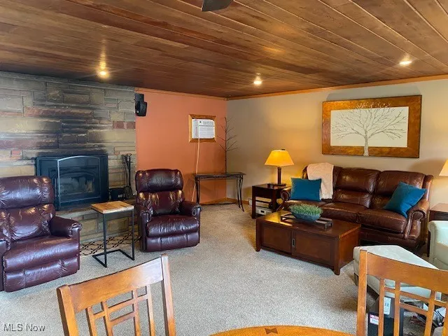 Carpeted living room with wood ceiling, ornamental molding, a wall mounted AC, and recessed lighting