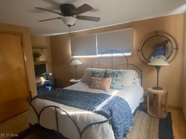 Bedroom featuring ceiling fan and wood finished floors