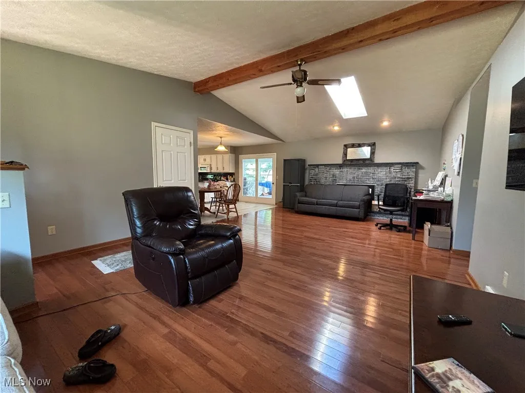 Enjoy television or gaming, huge fireplace behind the couch, kitchen to the left, four season room off the kitchen.