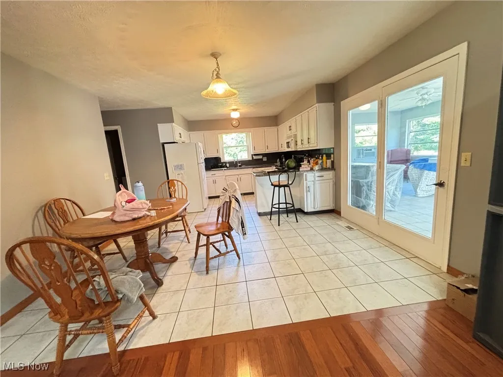 Kitchen counter has peninsula and solid surface countertops.