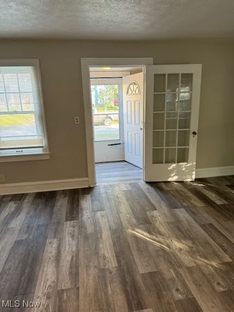 Foyer with wood finished floors and a textured ceiling