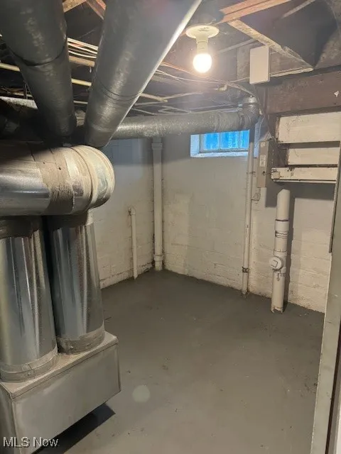 Unfinished basement featuring heating unit