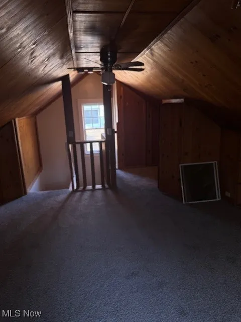 Bonus room with lofted ceiling, ceiling fan, carpet flooring, and wooden ceiling