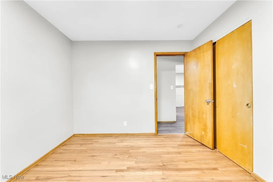 Unfurnished bedroom with light wood-type flooring and baseboards