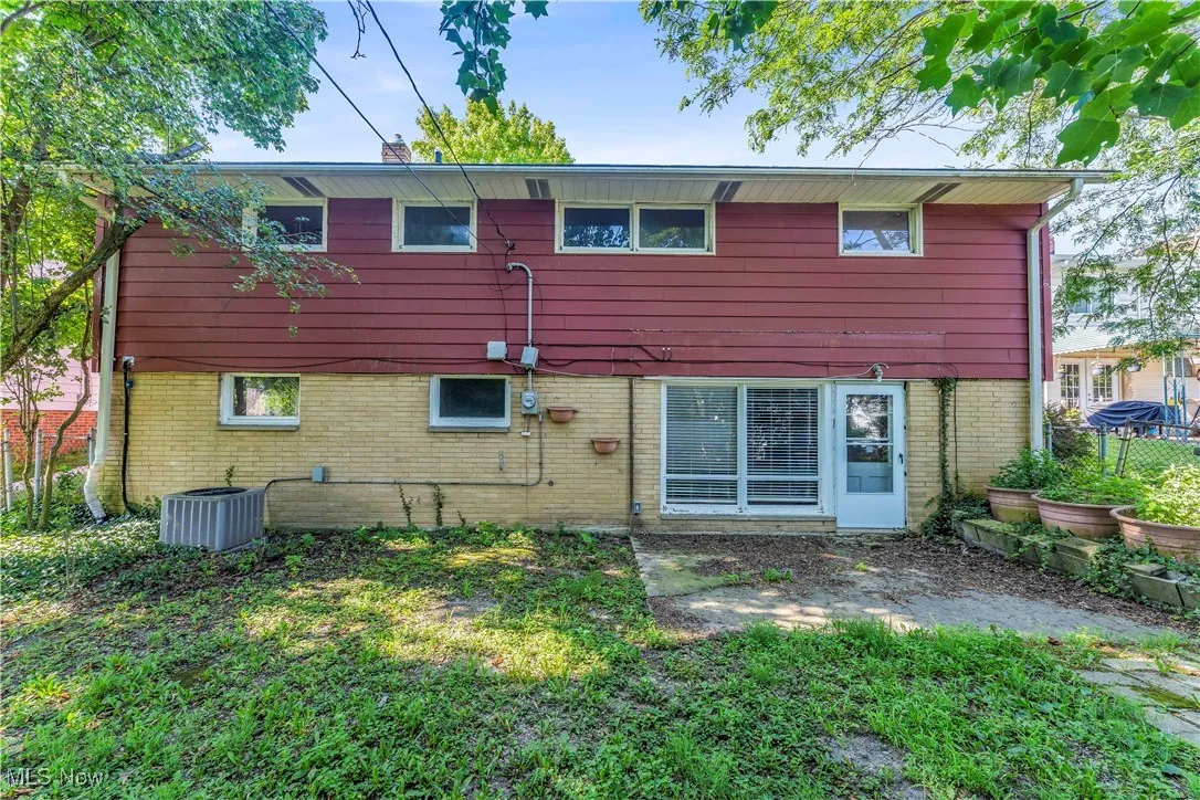 Back of property featuring brick siding