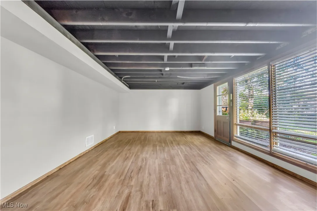 Empty room featuring wood finished floors and baseboards