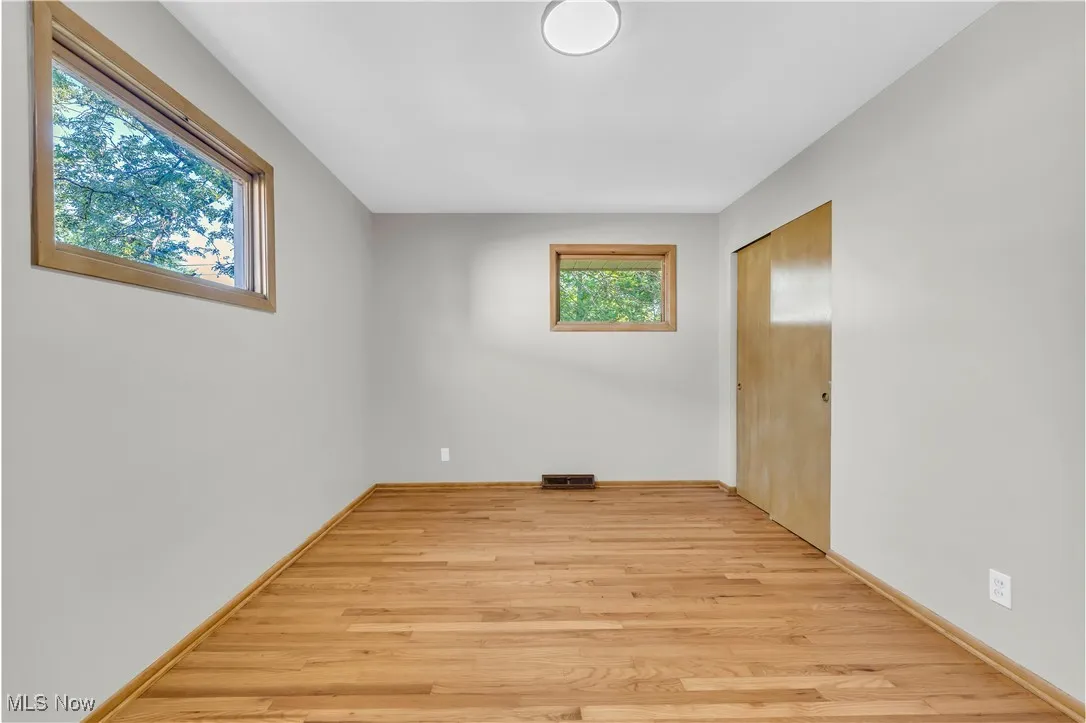 Unfurnished room featuring light wood-type flooring and baseboards