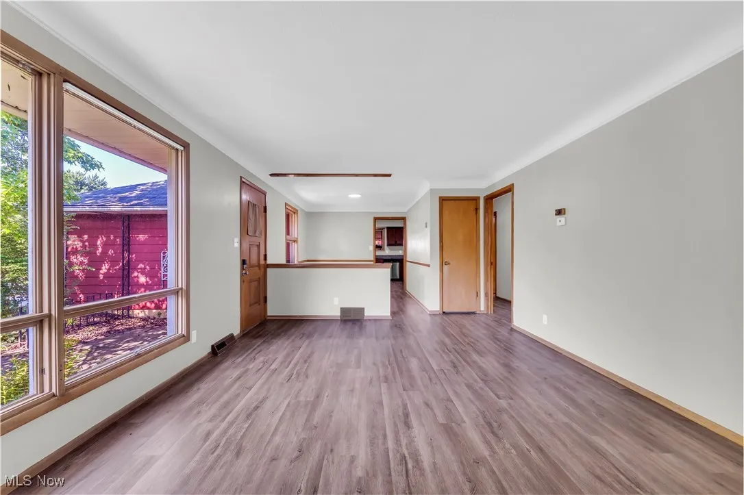 Unfurnished living room featuring wood finished floors, plenty of natural light, and recessed lighting
