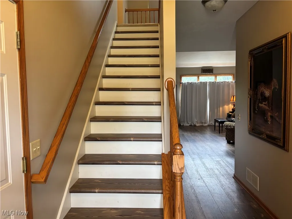 Staircase with hardwood / wood-style flooring