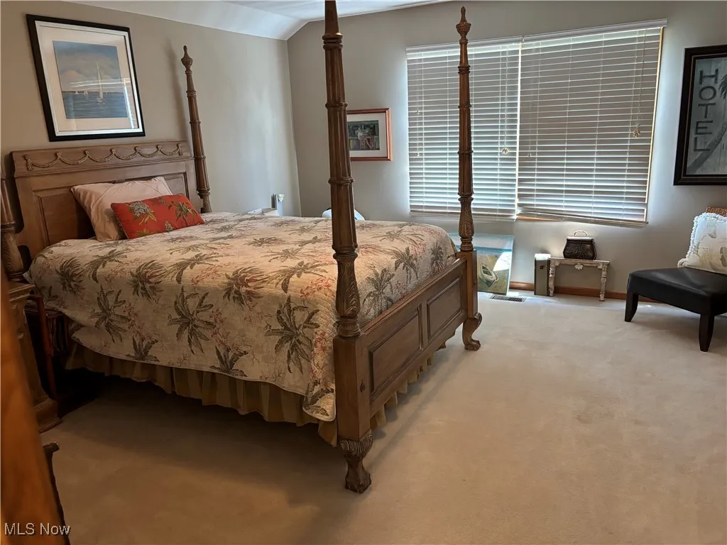 Bedroom featuring carpet flooring and baseboards
