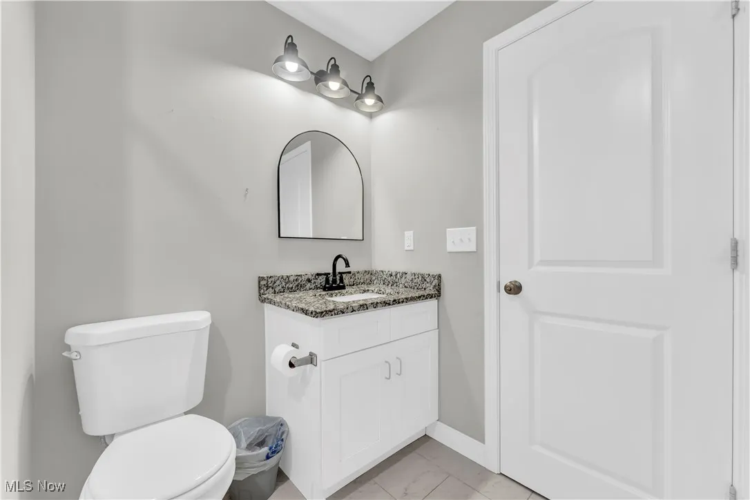 Bathroom featuring vanity and marble look tile flooring
