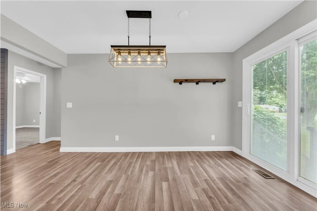 Unfurnished dining area featuring light wood-style flooring