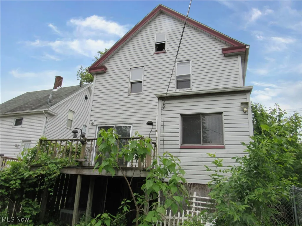 Rear view of house featuring a wooden deck