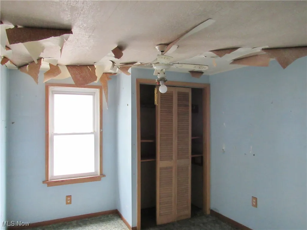 Unfurnished bedroom with a closet and a textured ceiling