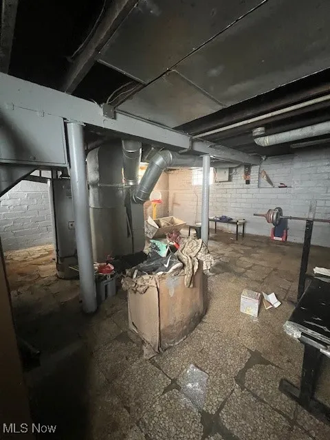 Unfinished below grade area with water heater and heating unit
