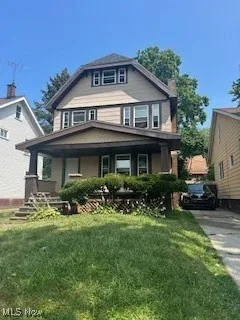 Traditional style home with a porch and a front yard