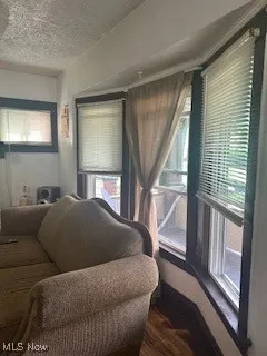 Living area with a textured ceiling and wood finished floors
