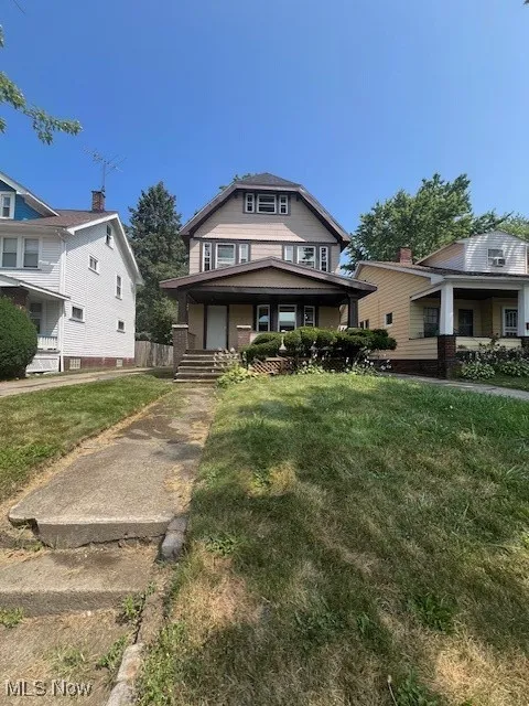 Traditional style home with a front yard and a porch